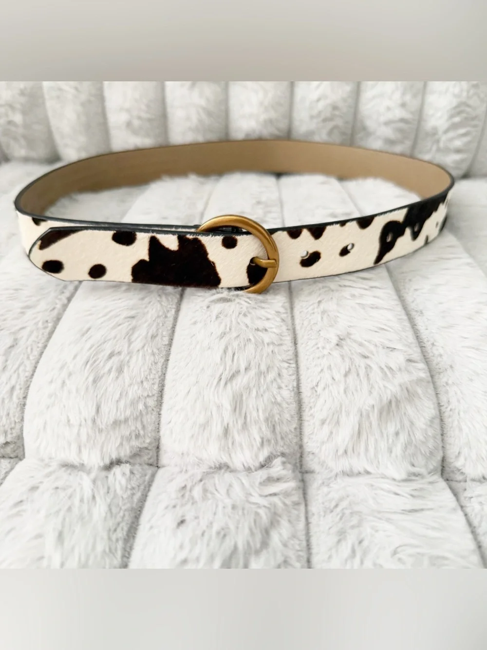 Urban Outfitters leather cow print calf hair belt.